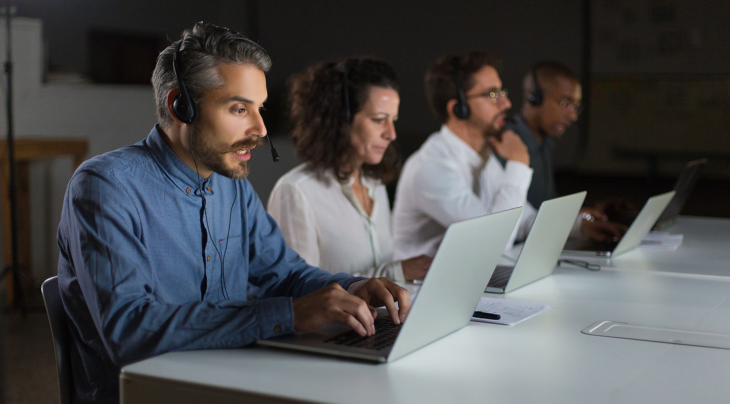 it support services agents working in a desk with several computers