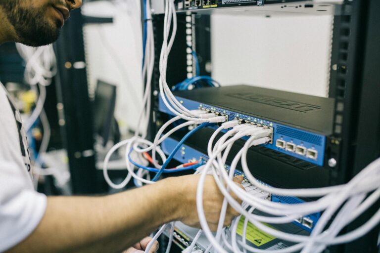 A man fixing wires of computer